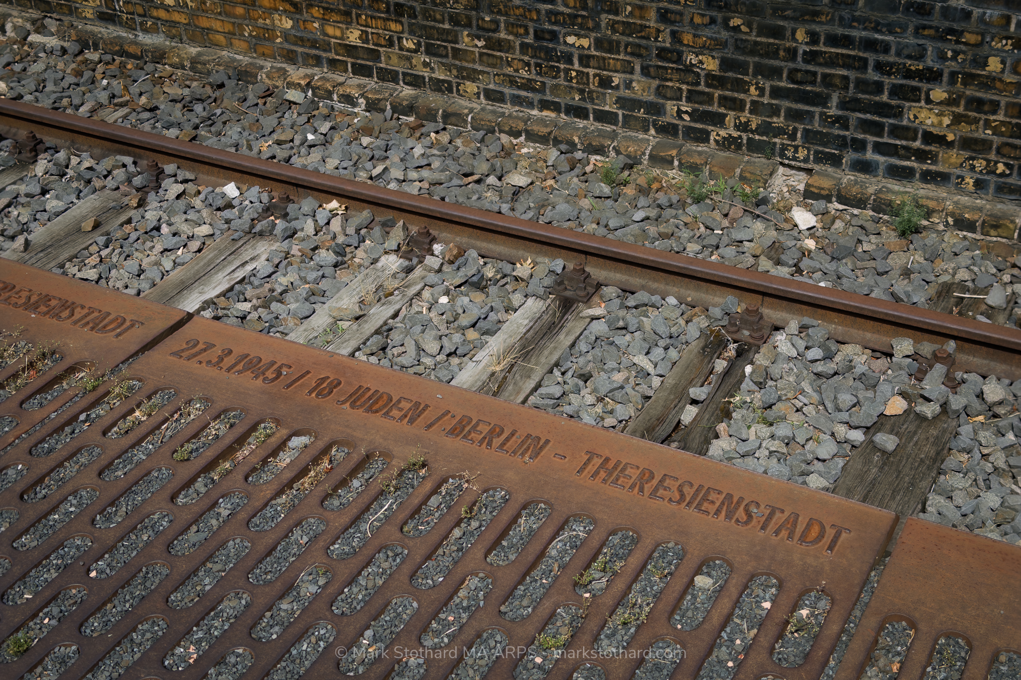 Rust stains the steel beside the railway tracks at Platform 17 in Berlin. Dates and destinations mark the deportation of Jews during the Second World War. From this platform, thousands were sent to ghettos and camps. The trains left. Few returned. The silence remains.